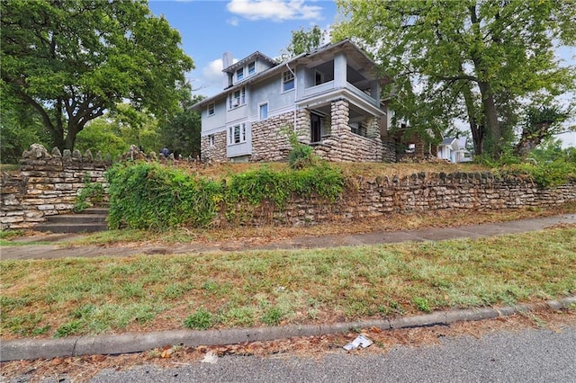 view of home's exterior with stucco siding and stone siding