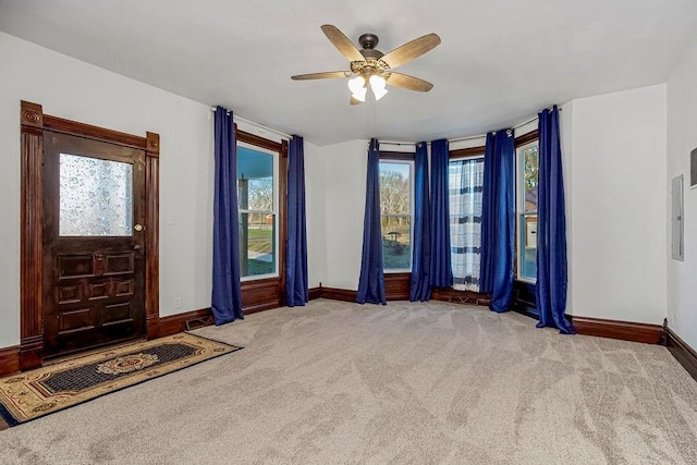 foyer with baseboards, carpet, and a ceiling fan