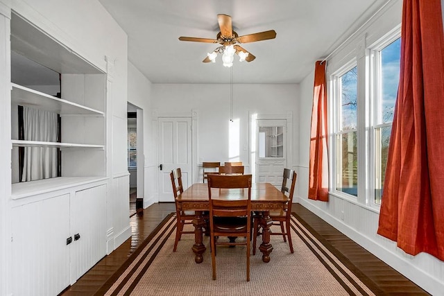 dining space with dark wood-type flooring and ceiling fan