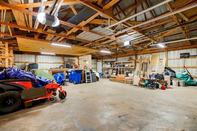 garage with a garage door opener and metal wall