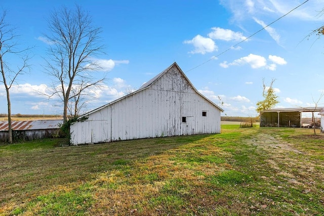 view of barn with a lawn