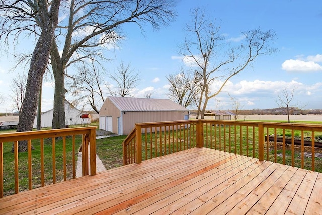 wooden terrace featuring an outbuilding, a lawn, and a garage