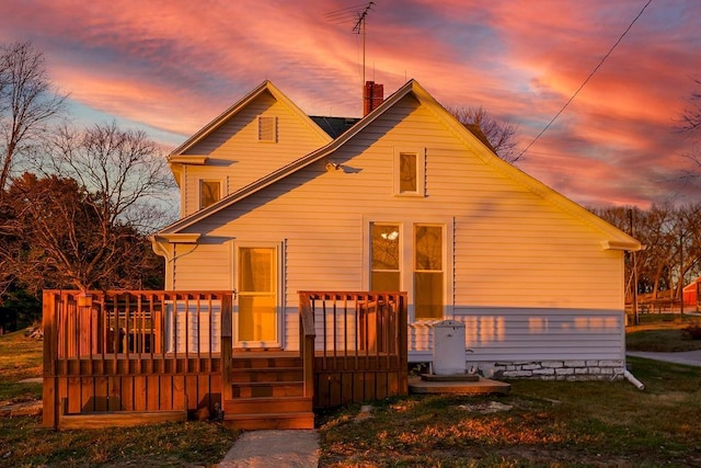 view of front of house with a chimney and a deck