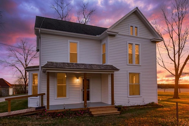 victorian house featuring covered porch and a front yard