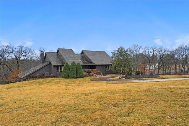 view of front of property featuring a chimney and a front yard