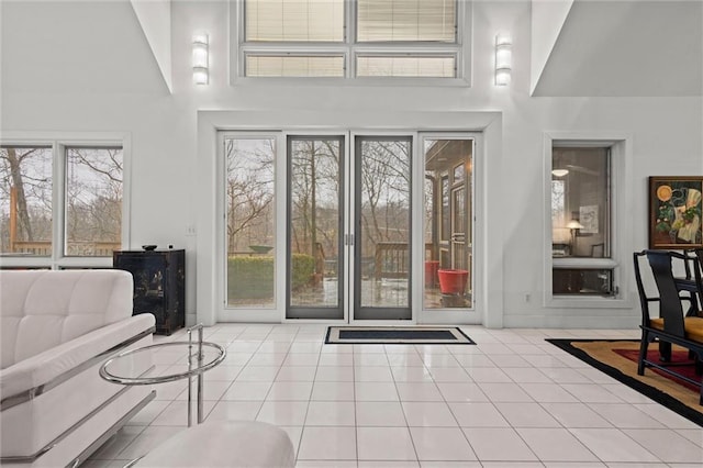 entryway featuring tile patterned floors and a high ceiling