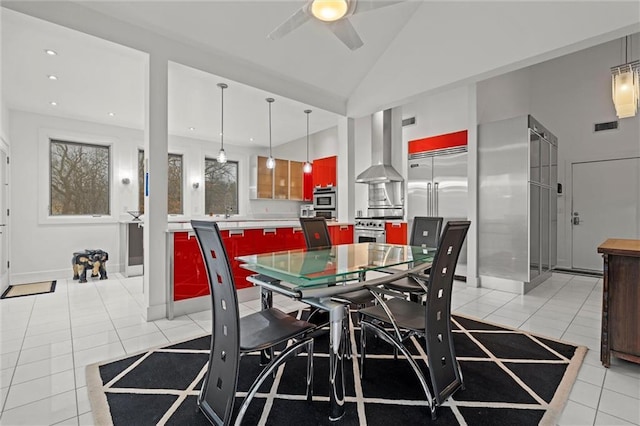 dining space with visible vents, baseboards, vaulted ceiling, light tile patterned floors, and a ceiling fan