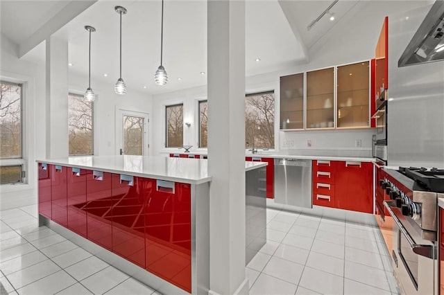 kitchen featuring light tile patterned flooring, a healthy amount of sunlight, stainless steel appliances, and modern cabinets