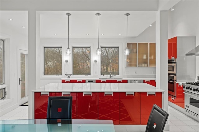 kitchen with a sink, light tile patterned floors, modern cabinets, and stainless steel appliances