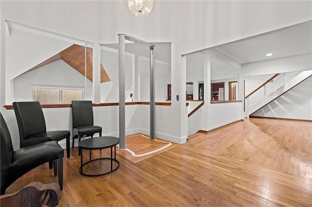 interior space featuring stairs, a notable chandelier, and wood finished floors