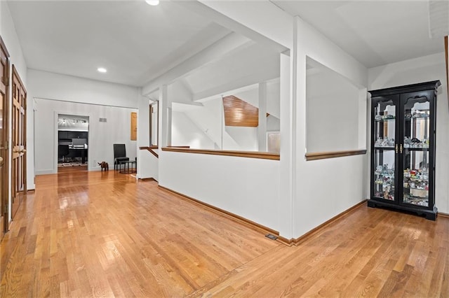 foyer entrance featuring baseboards and hardwood / wood-style floors