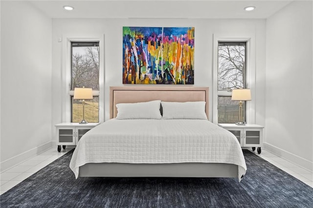 tiled bedroom with multiple windows and baseboards