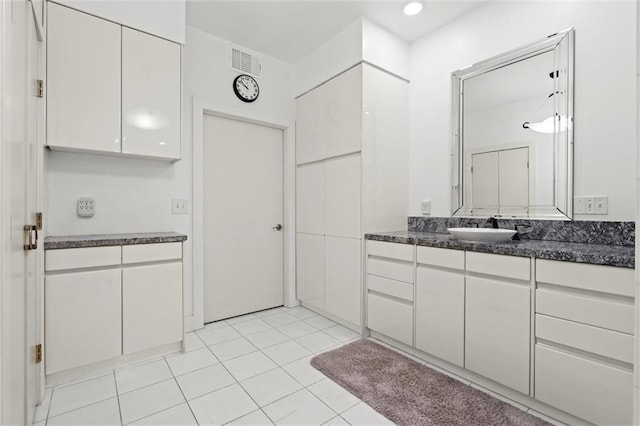 bathroom with tile patterned flooring, visible vents, and vanity