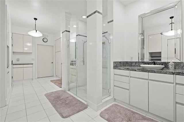 bathroom featuring a stall shower, vanity, and tile patterned flooring