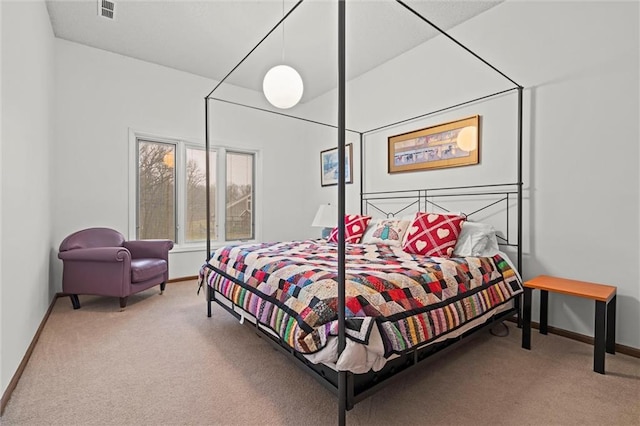 carpeted bedroom with visible vents and baseboards