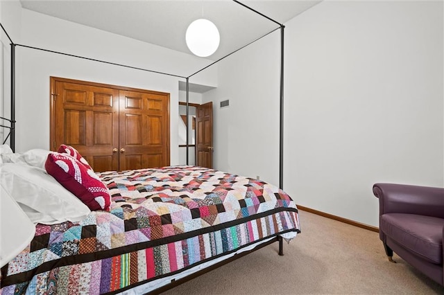 carpeted bedroom featuring visible vents, baseboards, and a closet