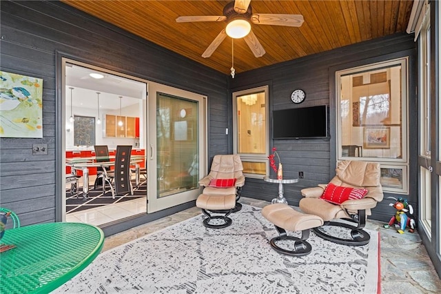 sunroom / solarium with wooden ceiling and a ceiling fan