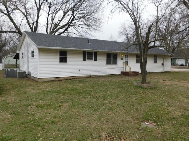 back of house with crawl space, a lawn, and cooling unit