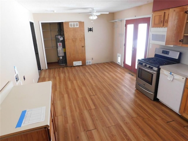 kitchen with visible vents, light countertops, water heater, light wood-style flooring, and white appliances