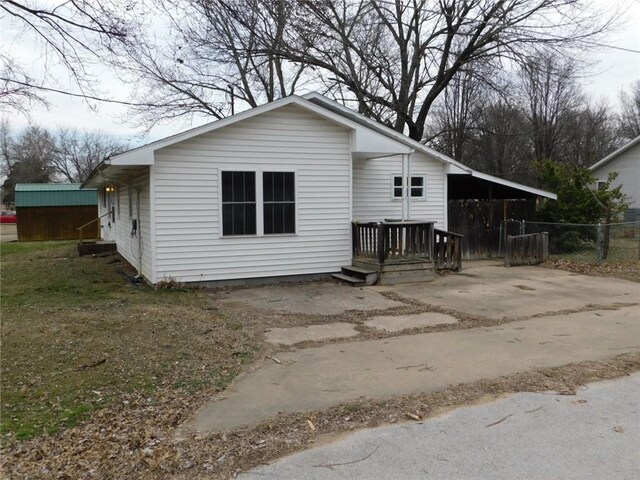 view of front of home featuring driveway and fence