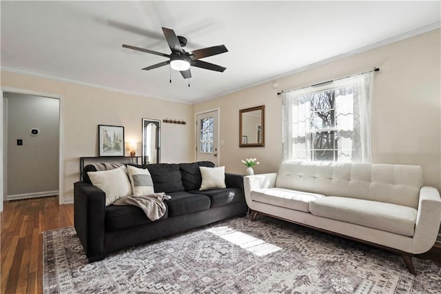 living room with a ceiling fan, wood finished floors, baseboards, and ornamental molding