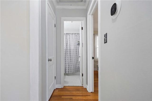 hall with crown molding and wood finished floors