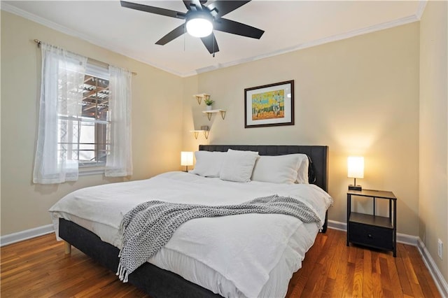 bedroom with baseboards, a ceiling fan, wood finished floors, and crown molding