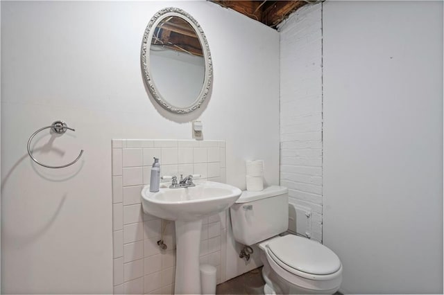 half bath featuring a sink and toilet