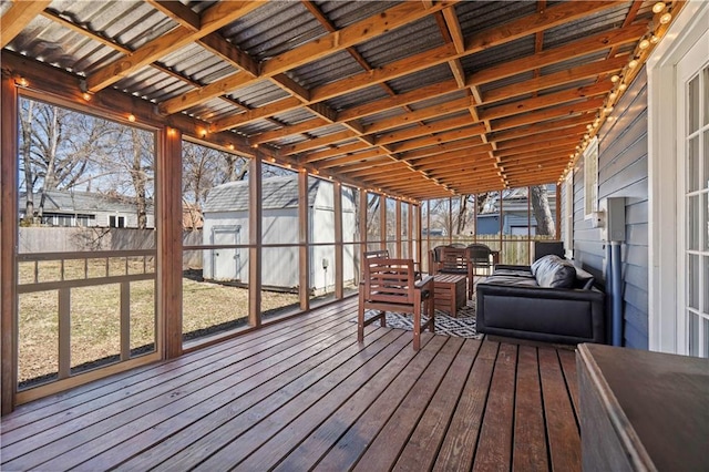 wooden terrace featuring a yard, an outbuilding, a fenced backyard, and a shed