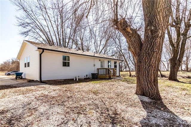 back of house featuring a deck and central AC