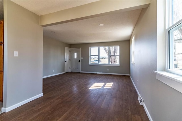 interior space featuring baseboards and dark wood-style flooring