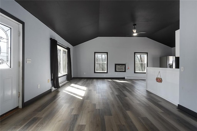 unfurnished living room featuring lofted ceiling, dark wood-style flooring, ceiling fan, a wall mounted air conditioner, and a baseboard heating unit