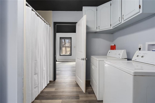 laundry room with wood finished floors and washing machine and dryer