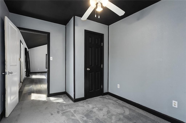 unfurnished bedroom featuring a closet, carpet flooring, a ceiling fan, and baseboards