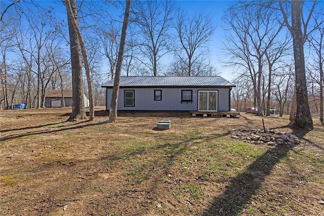 rear view of property with metal roof