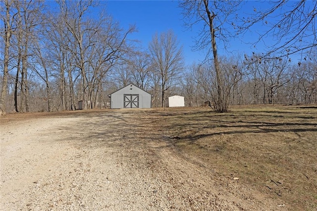 view of yard with an outbuilding and a storage shed