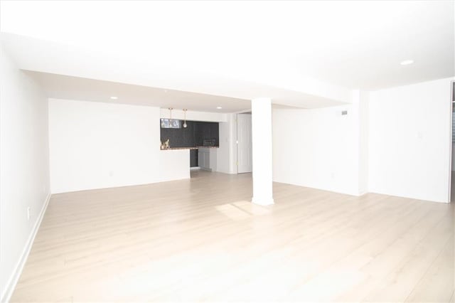 basement featuring light wood-style flooring and recessed lighting