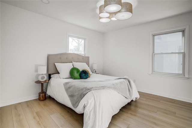 bedroom featuring baseboards and light wood-type flooring