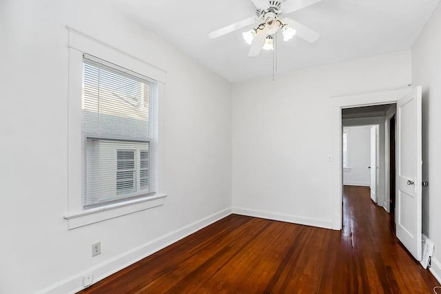 empty room featuring baseboards, wood-type flooring, and ceiling fan