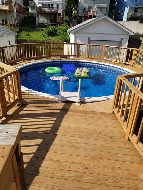 view of swimming pool featuring a fenced backyard, a fenced in pool, and an outdoor structure