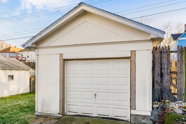 detached garage featuring fence