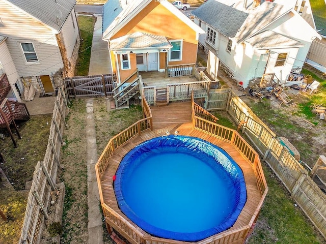 view of pool with a deck and a fenced backyard