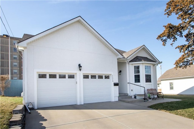 view of front of house featuring stucco siding, an attached garage, and concrete driveway