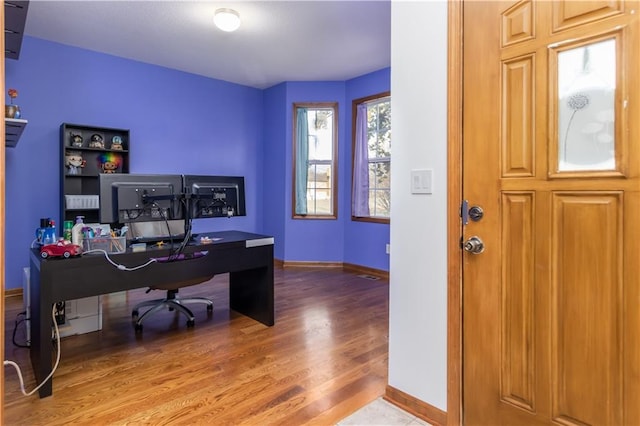 office space with wood finished floors and baseboards