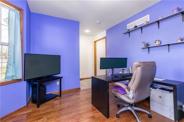 office space with baseboards and wood finished floors