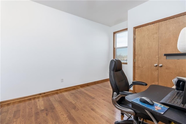 office space with baseboards and wood finished floors