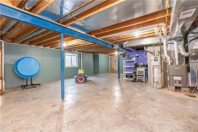 basement featuring water heater and heating unit