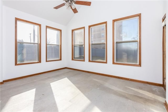 spare room featuring baseboards, ceiling fan, and vaulted ceiling