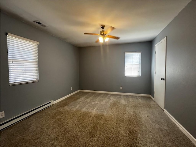 unfurnished room with visible vents, a ceiling fan, a baseboard heating unit, carpet, and baseboards