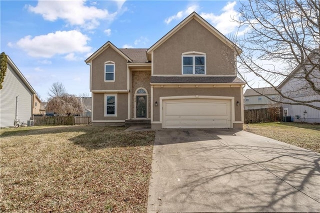 traditional-style house featuring stucco siding, an attached garage, concrete driveway, and fence